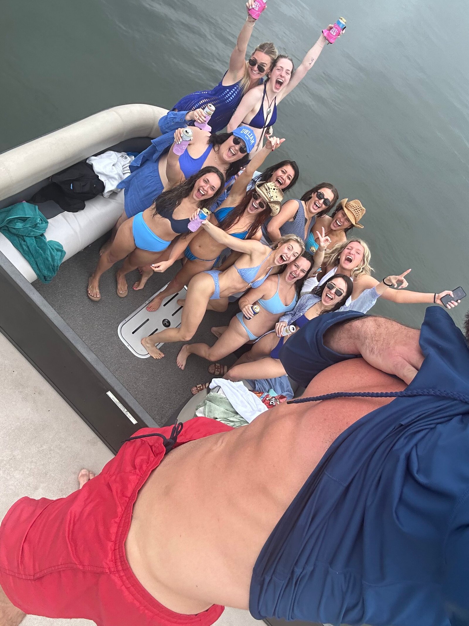 Romantic boat deck decorated with scattered red rose petals on wooden surface.